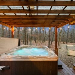 Hot tub lit from inside under the pergola