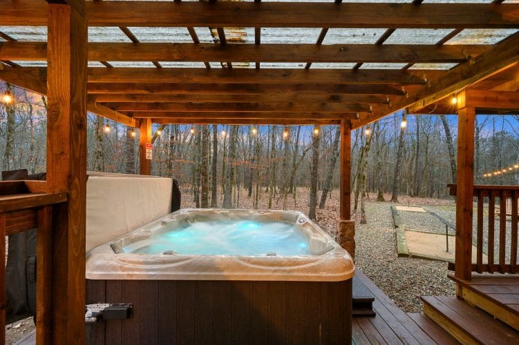 Hot tub lit from inside under the pergola