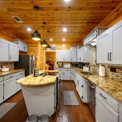 Kitchen with gray cabinets, granite counters and a center island