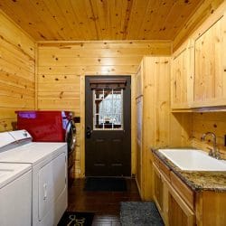 Laundry room with washer, dryer, utility sink and a back door