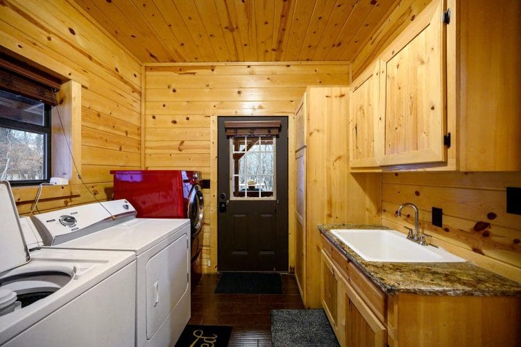 Laundry room with washer, dryer, utility sink and a back door