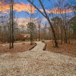 Gravel path with stone edging running through the woods