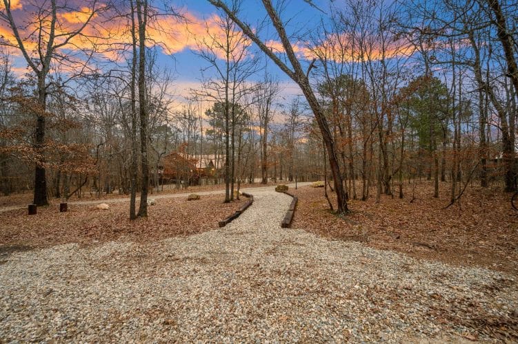 Gravel path with stone edging running through the woods