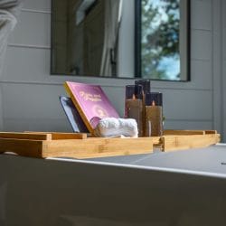 Close view of the bath tray with a book and candles