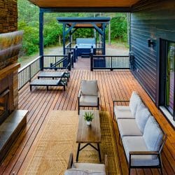 Covered deck with a gas fireplace, an outdoor sofa and lounge chairs