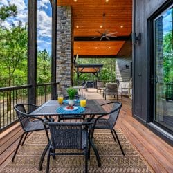 Deck dining table set for breakfast, with the hot tub pergola in view