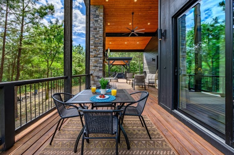 Deck dining table set for breakfast, with the hot tub pergola in view