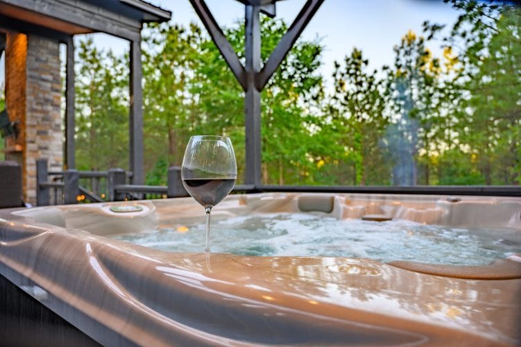Hot tub with a glass of red wine on the edge